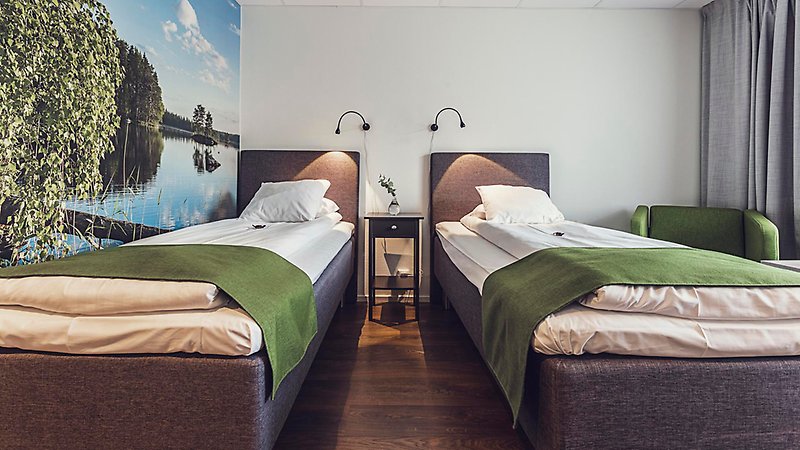 Två sängar på hotellrum.